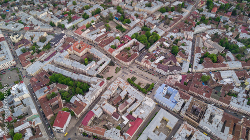 Aerial summer view of central part of beautiful ancient ukrainian city Chernivtsi with its streets, old residential buildings, town hall, churches etc. Beautiful town. UNESCO world heritage site. © dianagrytsku