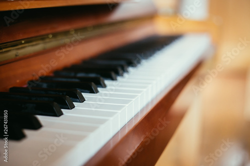 Rustic piano: close up picture of classical piano keys, selective focus