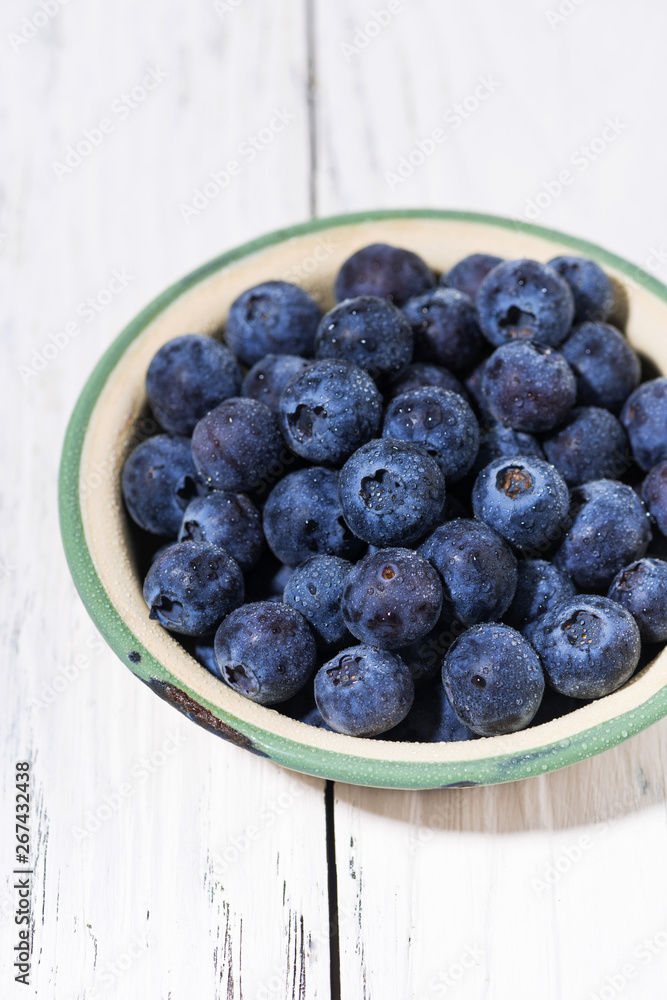 fresh juicy blueberries in a bowl, vertical fresh juicy blueberries in a bowl, vertical