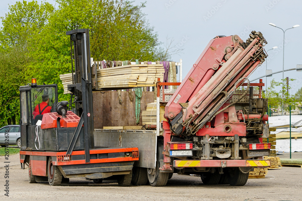 large lift truck load new wooden boards on truck large lift truck load new wooden boards on truck