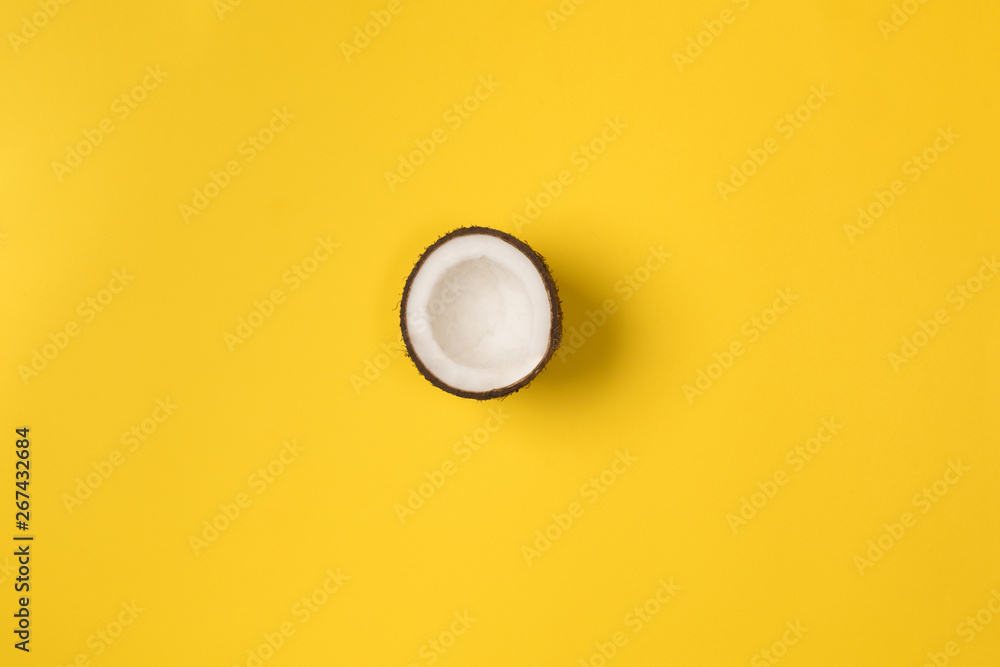 Summer composition. Coconut on yellow background. Summer concept. Flat lay, top view, copy space