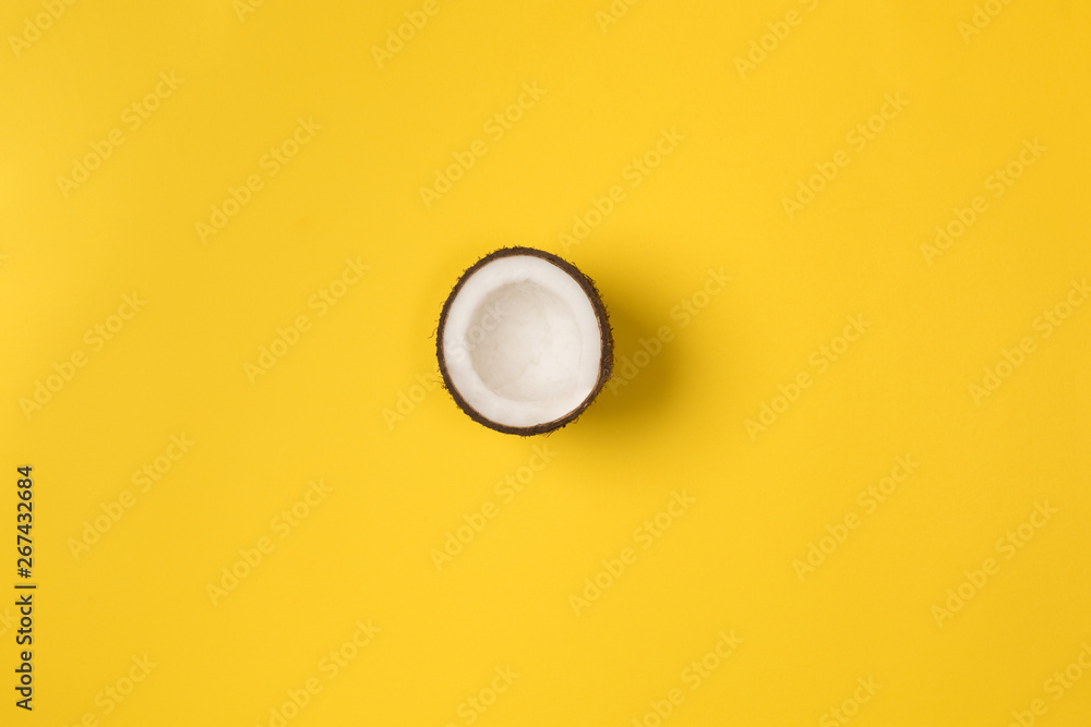 Summer composition. Coconut on yellow background. Summer concept. Flat lay, top view, copy space Summer composition. Coconut on yellow background. Summer concept. Flat lay, top view, copy space