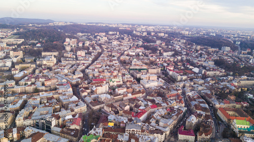 Fototapeta Naklejka Na Ścianę i Meble -  Rooftops of the old town in Lviv in Ukraine during the day. The magical atmosphere of the European city. Landmark, the city hall and the main square. Aerial view.