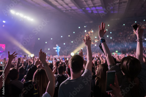 hands to the skies of people dancing and having fun at the live music concert