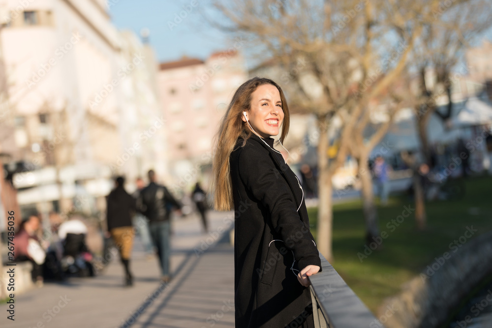 Fototapeta premium Beautiful girl listening to the music with earphones