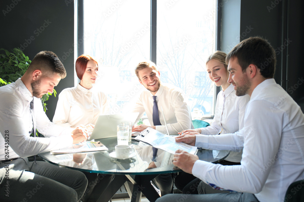 Group of business partners discussing ideas and planning work in office. Group of business partners discussing ideas and planning work in office.
