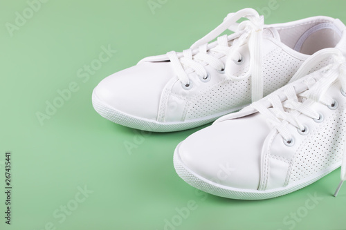 white sneakers on color background. copy space.