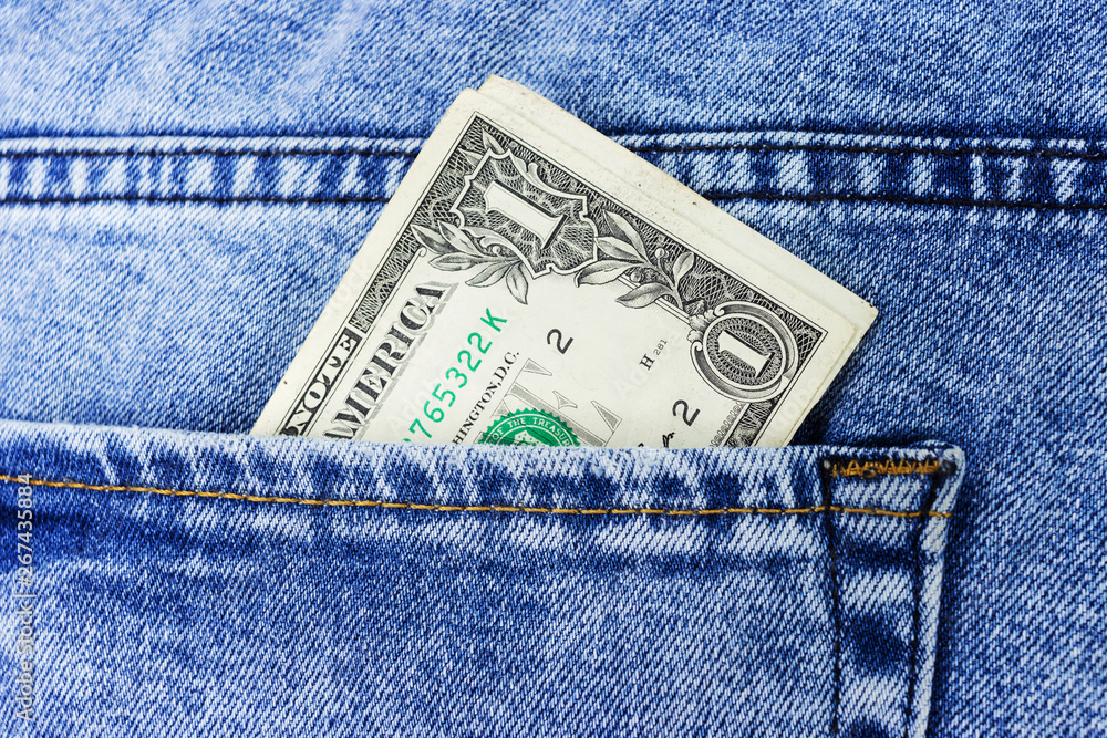 dollar bill sticking out from a blue jean pocket dollar bill sticking out from a blue jean pocket