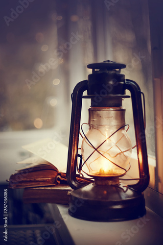 Vintage kerosene lamp and old books