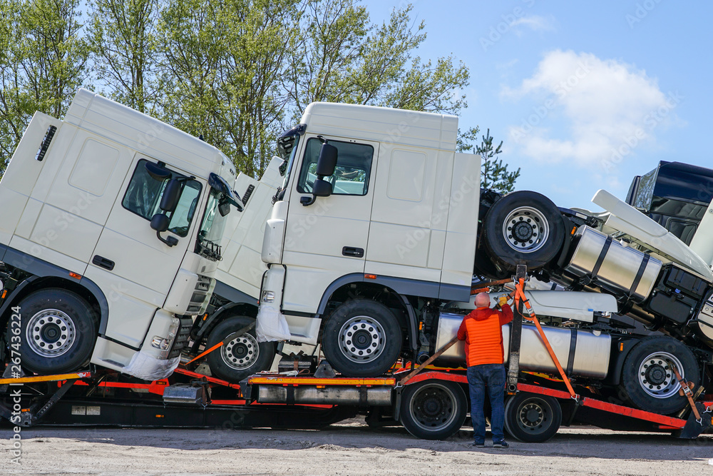new trucks on a carrier truck, that delivers them to customers Stock
