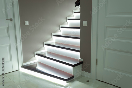 modern white staircase with wooden floor with LED backlighting