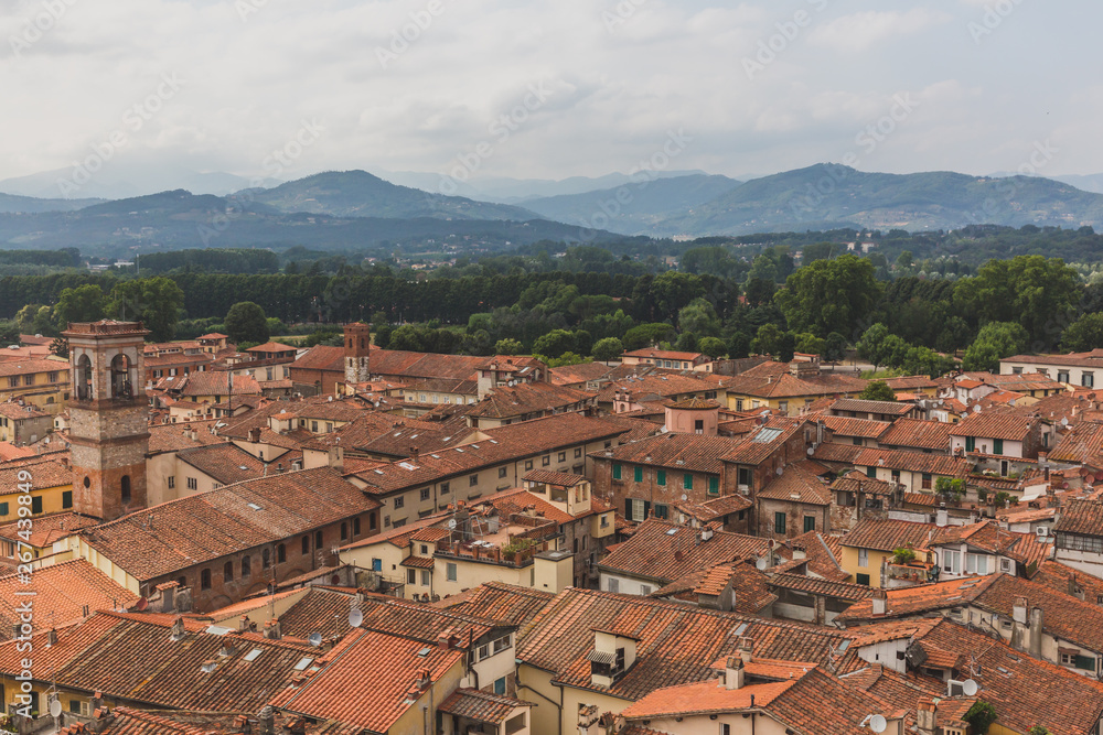 Architecture and buildings of Lucca, Tuscany, Italy, with mountain landscape in the distance
