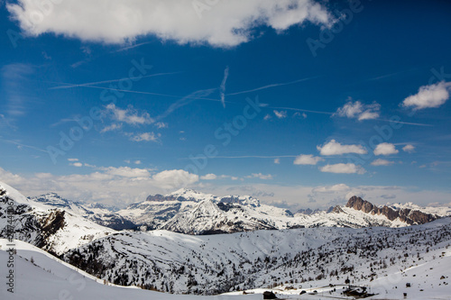 Beautiful winter landscape with snow in Alps. Dolomites. Panorama of snow mountain landscape with blue sky. Sunshine. Peaks. Rocks. Alps. Italy. © romeof