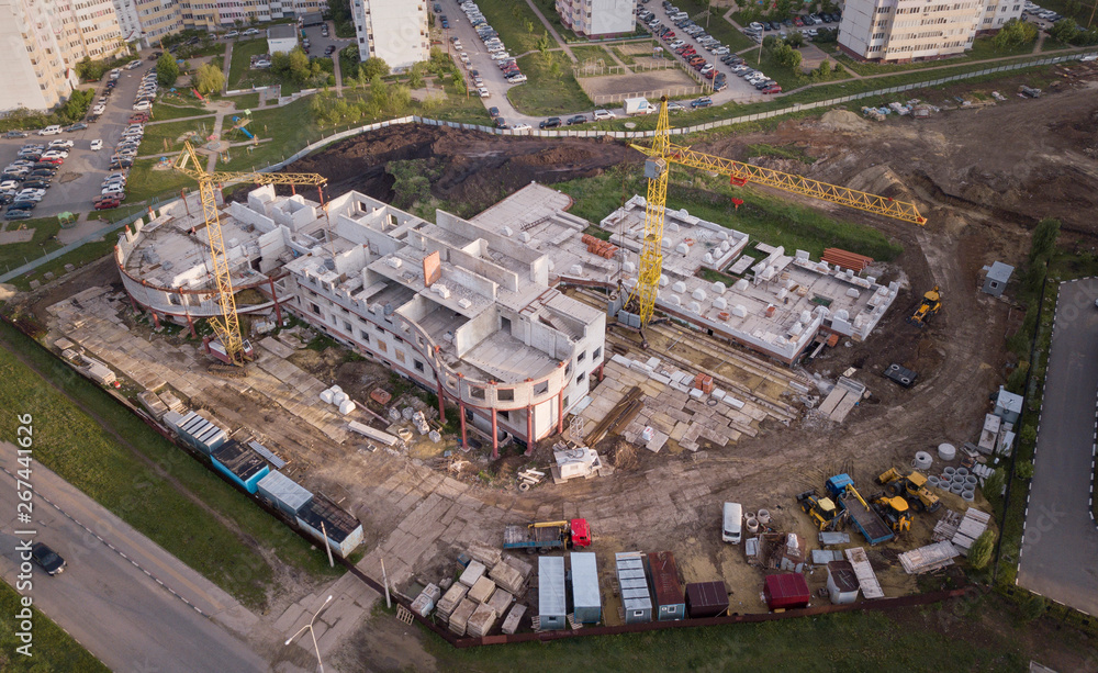 aerial view of the construction site and yellow cranes. new apartment building in progress