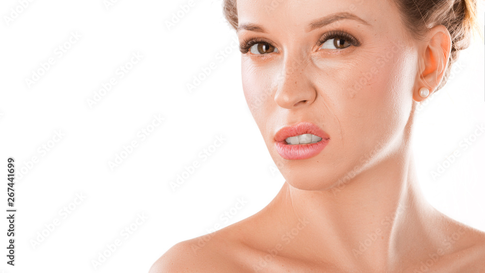 disgusted and frowning young woman on a white background disgusted and frowning young woman on a white background