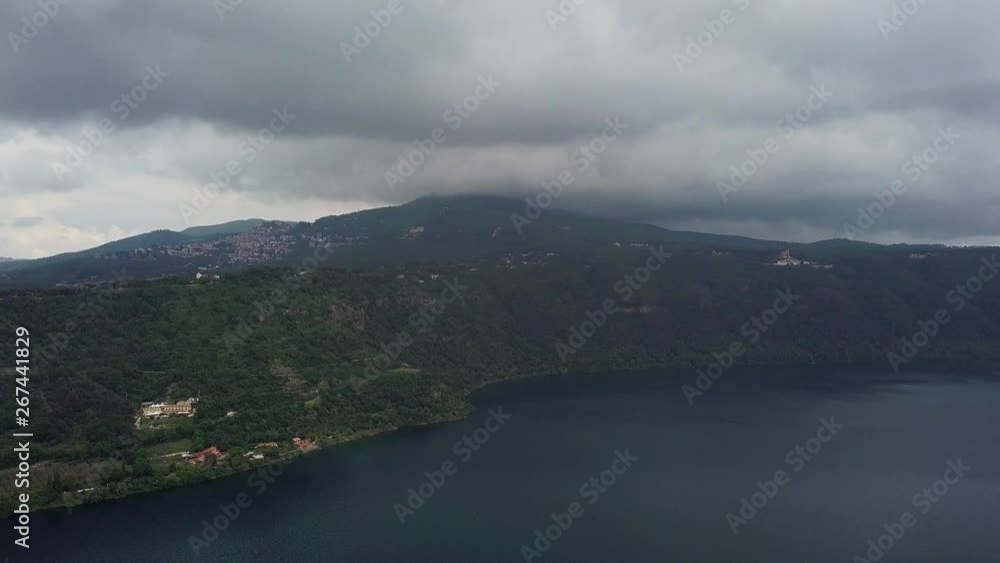 aerial view of coast of Lake Albano and volcanic mountain road cars traffic clouds sky, Castel Gandolfo Rome, Italy aerial view of coast of Lake Albano and volcanic mountain road cars traffic clouds sky, Castel Gandolfo Rome, Italy