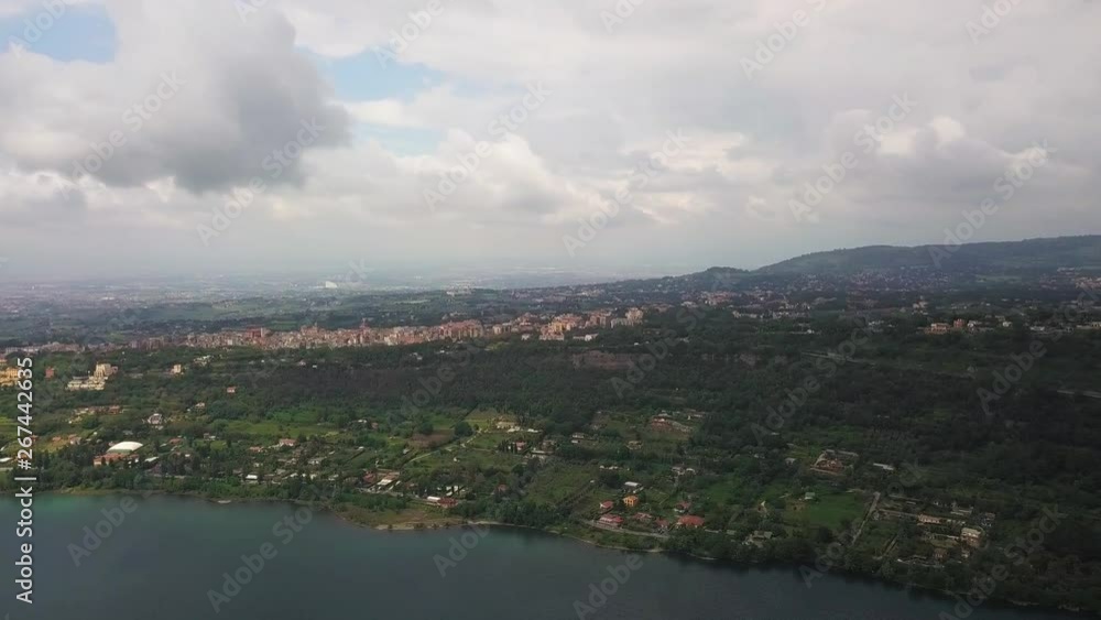 aerial view of coast of Lake Albano and volcanic mountain road cars traffic clouds sky, Castel Gandolfo Rome, Italy