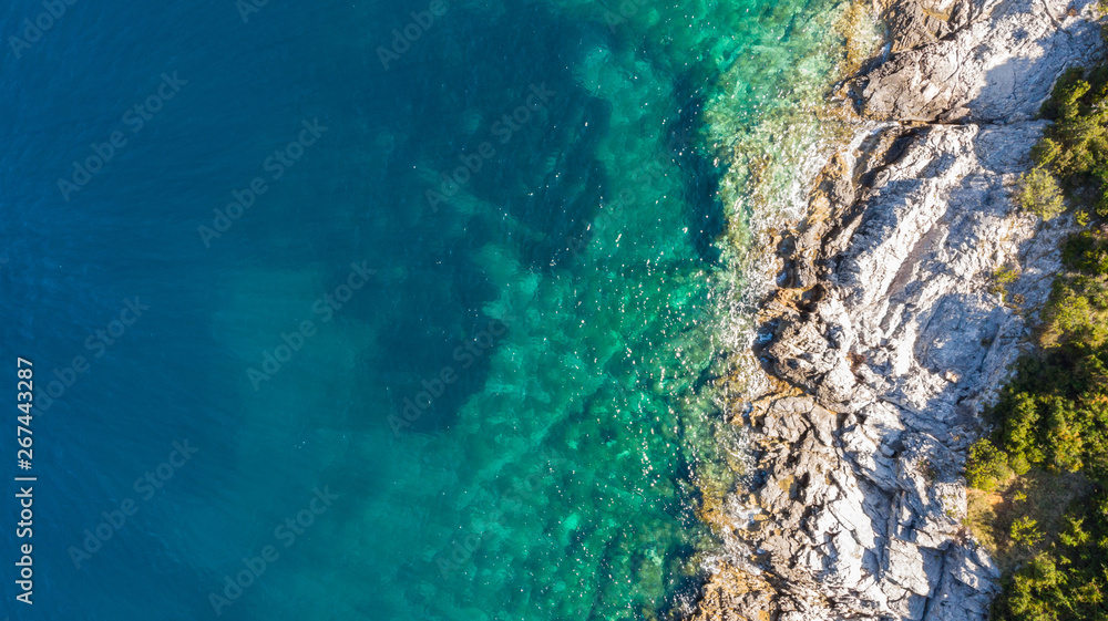 Spectacular aerial sea landscape of rocky coast and crystal clear water.