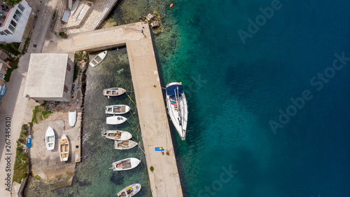 Drop down view of fishing port with boats tied in.