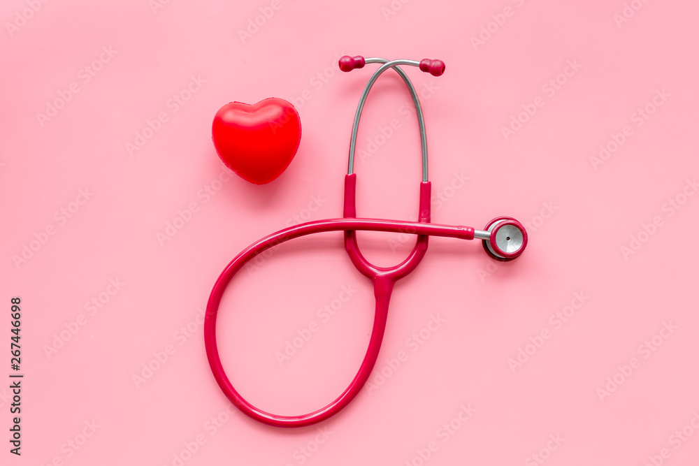 diagnostic and cure of cardiac disease with stethoscope and heart on pink background top view diagnostic and cure of cardiac disease with stethoscope and heart on pink background top view