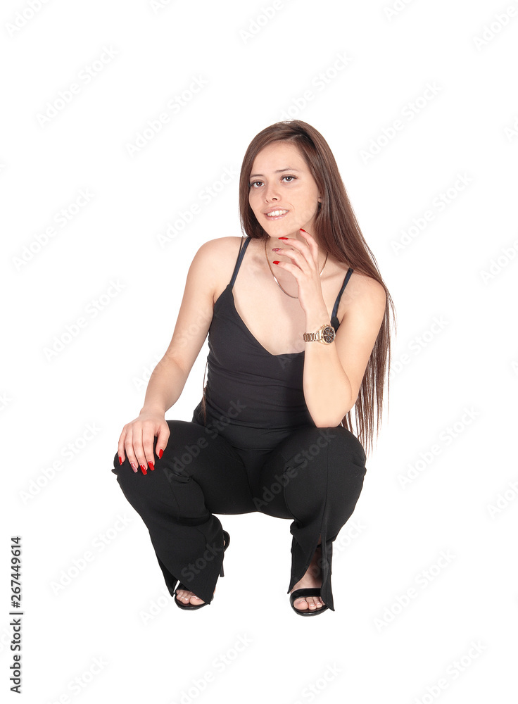 Lovely young woman crouching on the floor Lovely young woman crouching on the floor