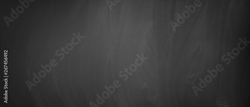 Old, dirty blackboard or chalkboard as a black background photo