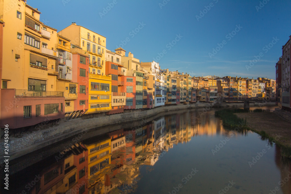 Girona buildings close to river during clear sunset