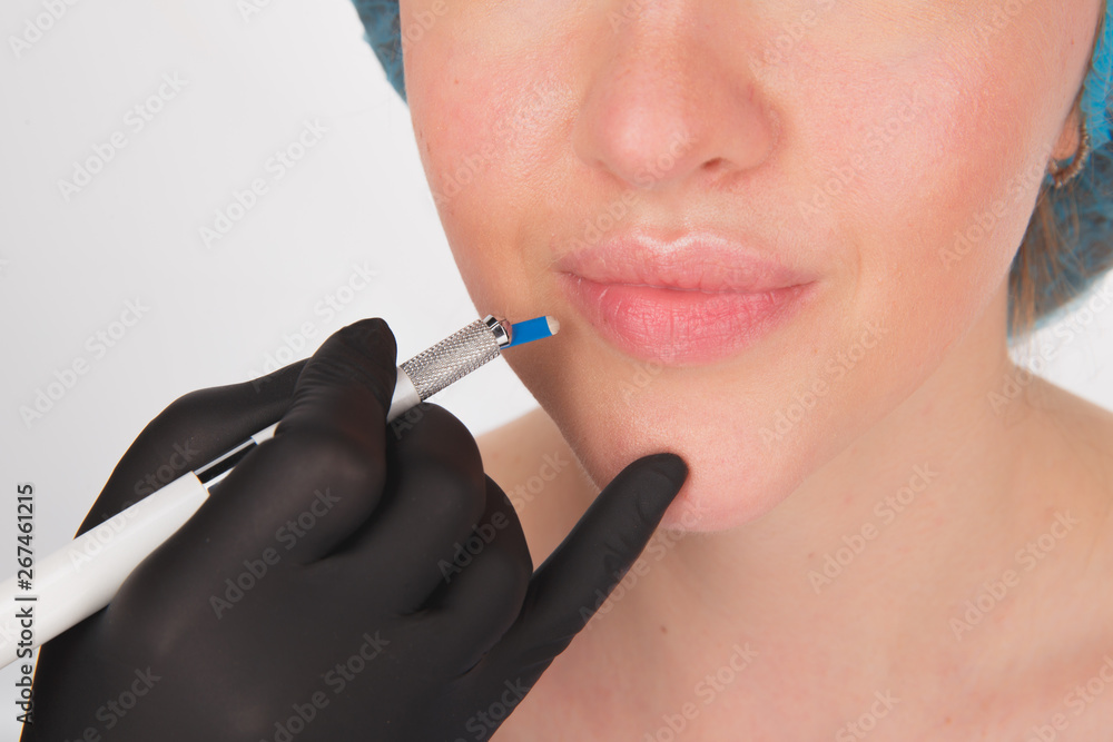 Permanent Makeup For Eyebrows. Microblading brow. Beautician Doing Eyebrow Tattooing For Female Face. Beautiful young girl in a beauty salon Permanent Makeup For Eyebrows. Microblading brow. Beautician Doing Eyebrow Tattooing For Female Face. Beautiful young girl in a beauty salon
