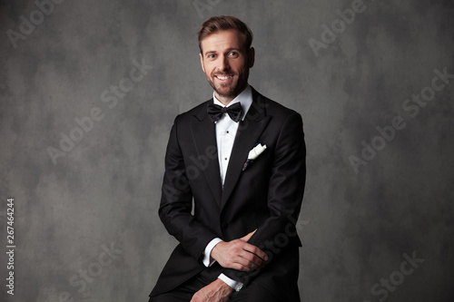 Happy looking man smiling at the camera while wearing tuxedo