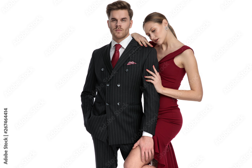 Charming young guy holding his girlfriend's leg Charming young guy holding his girlfriend's leg