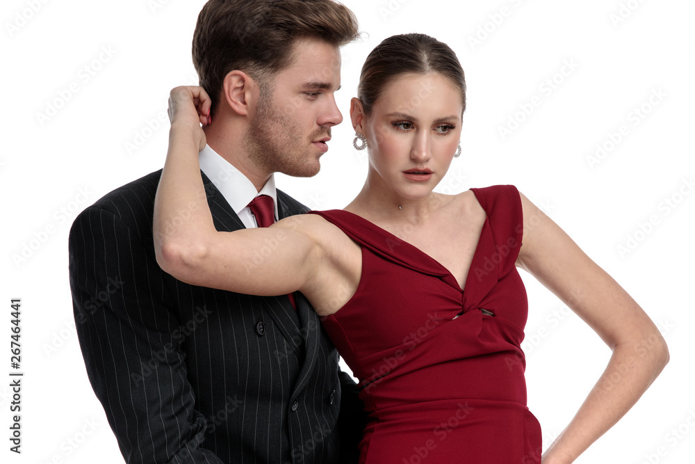 Couple dressed in a black suit and red dress holding Couple dressed in a black suit and red dress holding
