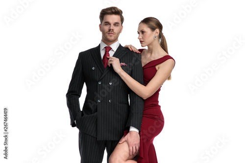 Handsome guy dressed getting his tie fixed by his girlfriend