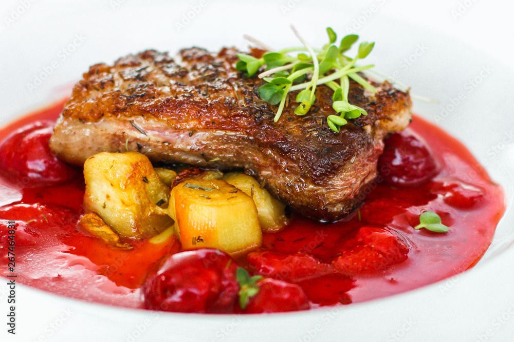 fried duck breast with berry sauce and vegetables (main dish). food background. top fried duck breast with berry sauce and vegetables (main dish). food background. top