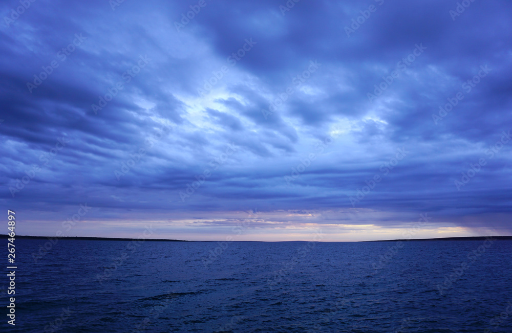 Dramatic sky and sea in dark blue color tone. Seascape horizon after storm