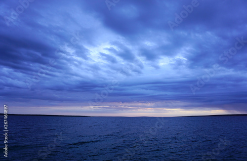 Dramatic sky and sea in dark blue color tone. Seascape horizon after storm
