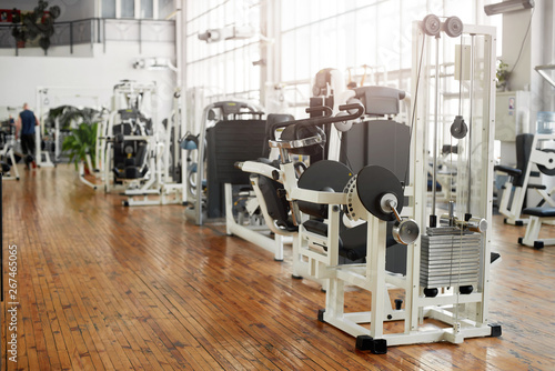Gym interior with equipment. Training equipment in modern gym. Fitness center background.