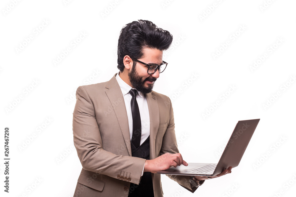 Egiptyan young businessman wearing a suit and holding his laptop isolated on white background. Egiptyan young businessman wearing a suit and holding his laptop isolated on white background.