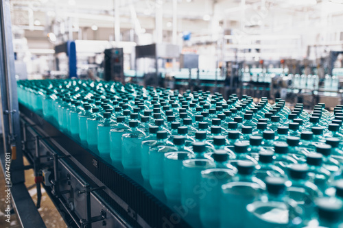 Bottling plant - Water bottling line for processing and bottling pure spring water into small bottles. Selective focus.