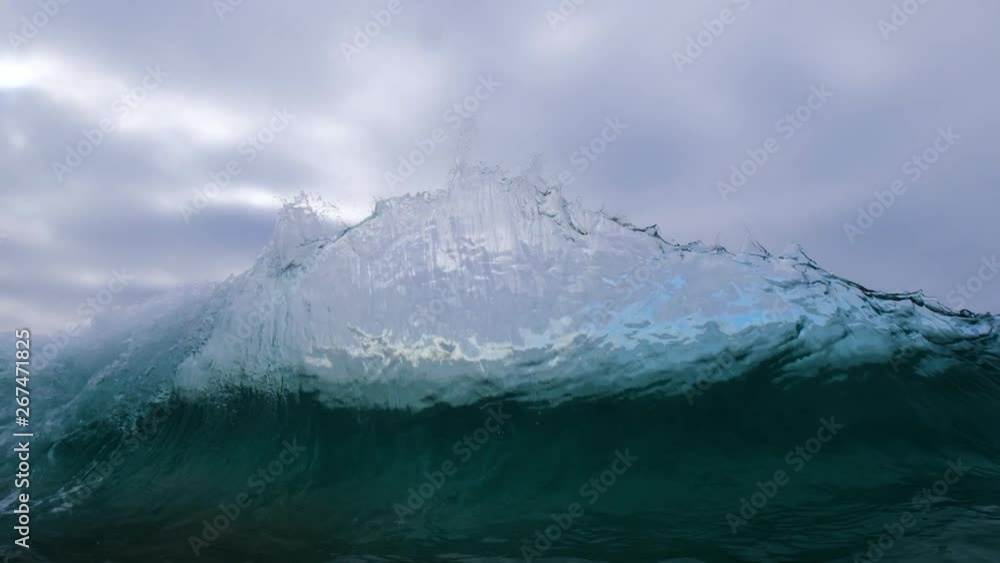 custom made wallpaper toronto digitalwater shot of backwash hitting wave looking out to sea as large sheet of glassy water erupts skyward and falls.  5X slow motion captures the action.  dark moody skies add drama.