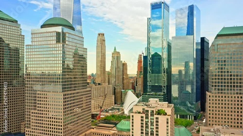 Aerial drone footage of downtown New York skyline. The camera pulls back from Lower Manhatttan skyline between tall skyscrapers photo