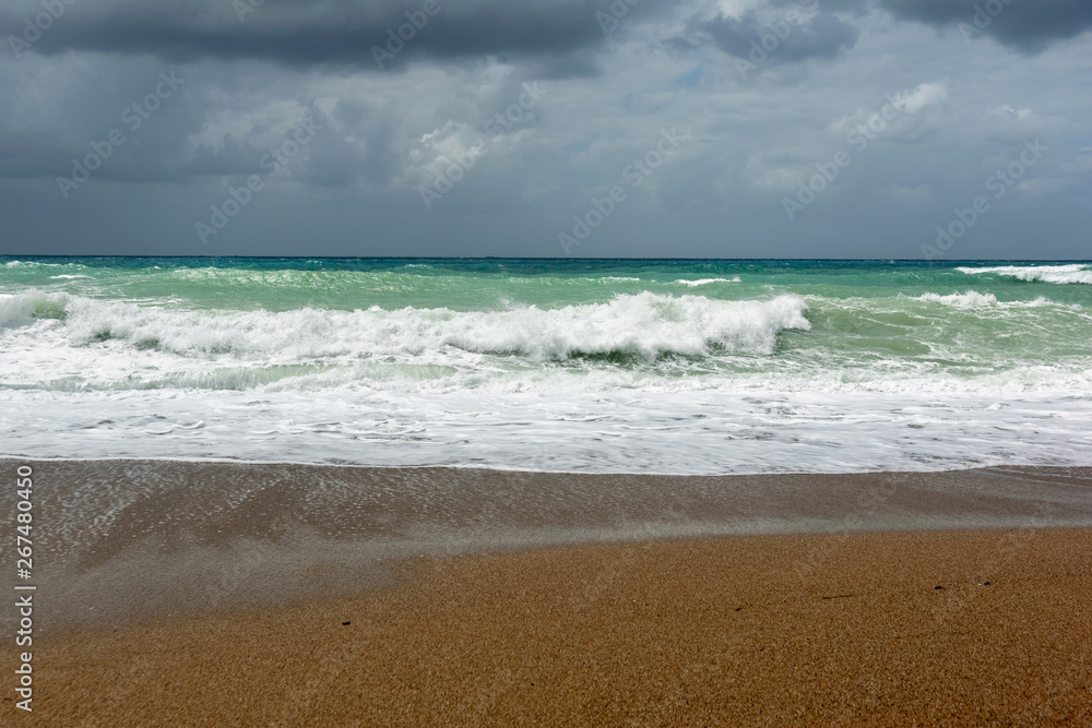 Waves On sand beach of the Aegean Sea in Rhodes.