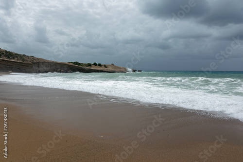 Fototapeta Naklejka Na Ścianę i Meble -  Waves On sand beach of the Aegean Sea in Rhodes.