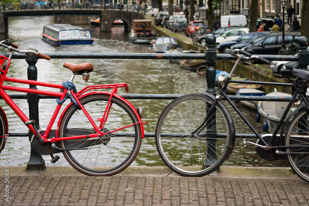 Two bicycles on a bridge over a canal in Amsterdam, Netherlands