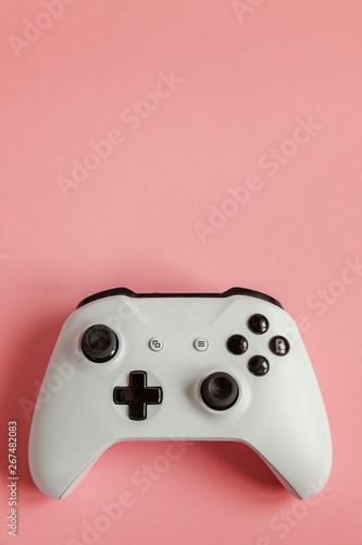 White joystick gamepad, game console on pastel pink colourful trendy modern pin-up background. Computer gaming competition videogame control confrontation concept. Cyberspace symbol