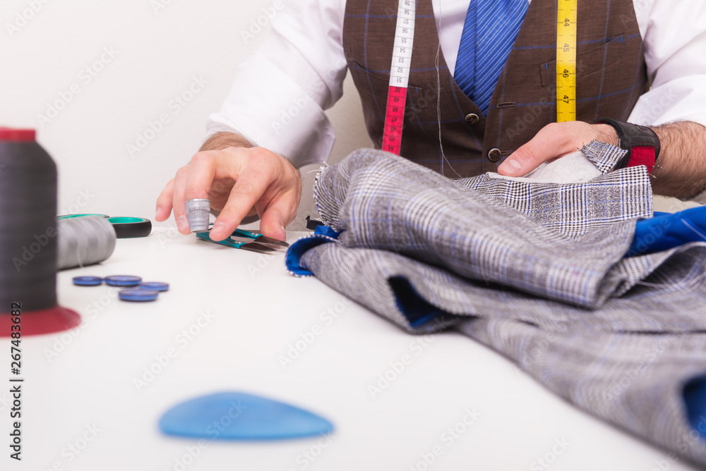 Male tailor hands during sewing process