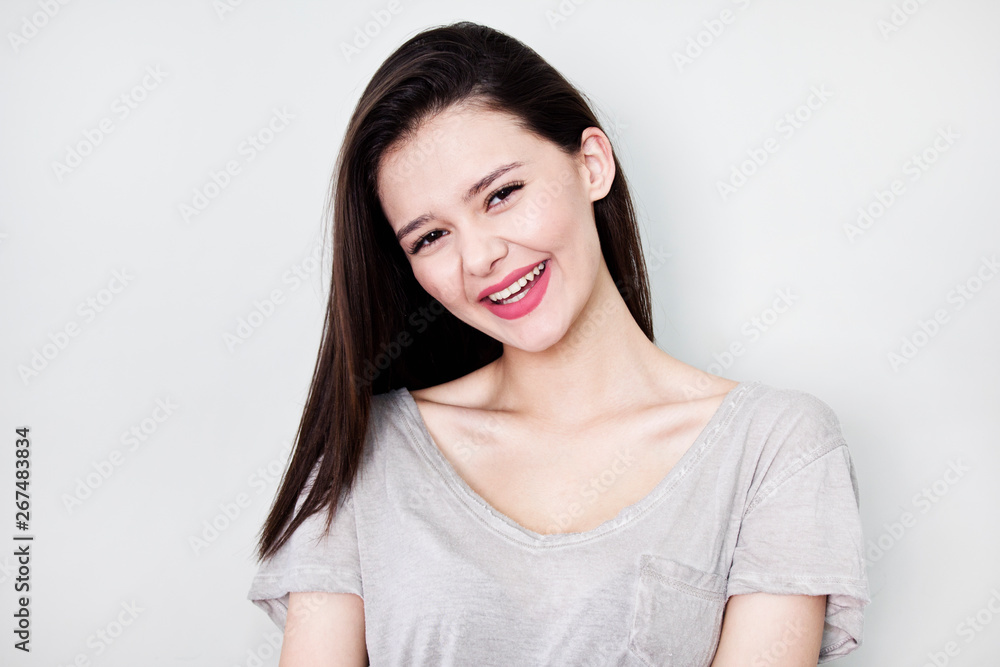 Portrait of young beautiful cute cheerful girl smiling looking at camera over white background. Portrait of young beautiful cute cheerful girl smiling looking at camera over white background.