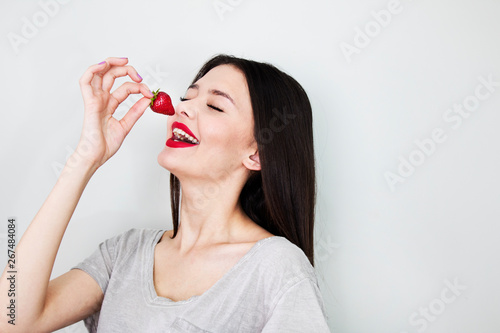 Woman eating fresh strawberry on white background.dieting concept.healthy lifestyle 
