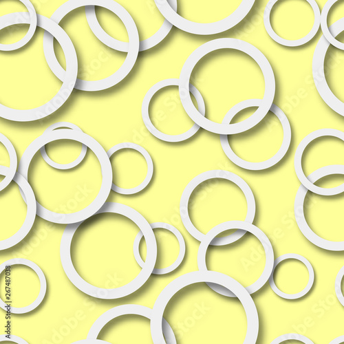 Abstract seamless pattern of randomly arranged white rings with soft shadows on yellow background
