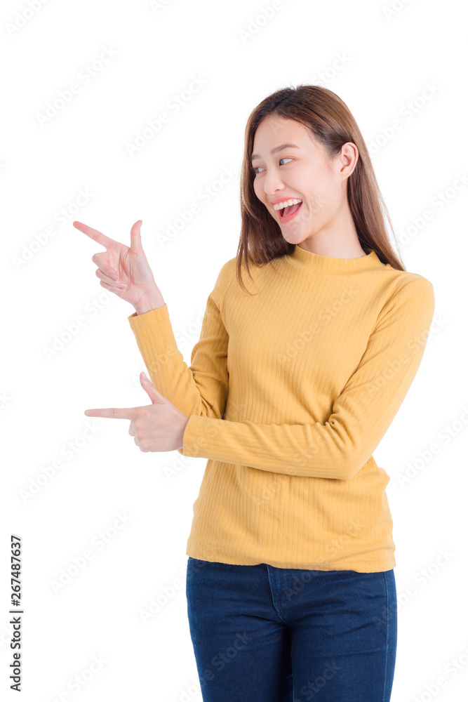Beautiful asian woman smiling and pointing finger to copy space isolated over white background Beautiful asian woman smiling and pointing finger to copy space isolated over white background
