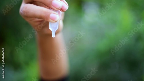 Boy dropping eye drop medicine healing his eye pain, health care eye medicine concept